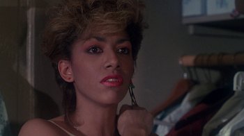 Movie still from “Krush Groove” (1985), directed by Michael Schultz – A woman is putting makeup on her face; Close Up shot, Over the shoulder angle