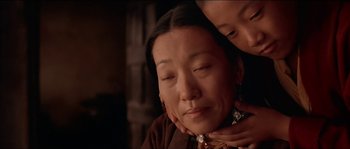 Movie still from “Kundun” (1997), directed by Martin Scorsese – An older asian woman with a younger asian man; Close Up shot, Low angle