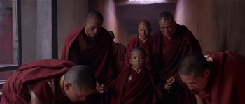 Movie still from “Kundun” (1997), directed by Martin Scorsese – A group of men in red and yellow robes standing next to each other; Medium shot, High angle