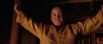 Movie still from “Kundun” (1997), directed by Martin Scorsese – A small child wearing a yellow jacket; Close Up shot, Low angle