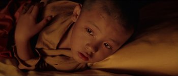 Movie still from “Kundun” (1997), directed by Martin Scorsese – A young boy's face with tears in his eyes; Close Up shot, High angle