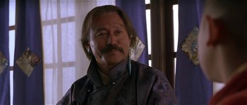 Movie still from “Kundun” (1997), directed by Martin Scorsese – A person with long brown hair; Close Up shot, Low angle