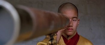 Movie still from “Kundun” (1997), directed by Martin Scorsese – A young boy is looking through a telescope; Extreme Close Up shot, Low angle