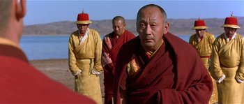 Movie still from “Kundun” (1997), directed by Martin Scorsese – A group of men standing next to each other on top of a hill; Close Up shot, Over the shoulder angle