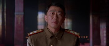 Movie still from “Kundun” (1997), directed by Martin Scorsese – A person wearing a military uniform; Close Up shot, Low angle
