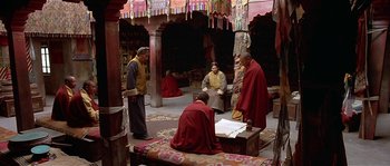 Movie still from “Kundun” (1997), directed by Martin Scorsese – A group of monks sitting in a room; Wide shot, High angle
