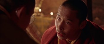Movie still from “Kundun” (1997), directed by Martin Scorsese – A person looking at a camera; Close Up shot, Over the shoulder angle