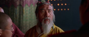 Movie still from “Kundun” (1997), directed by Martin Scorsese – An old man with a long white beard; Close Up shot, Low angle
