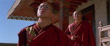 Movie still from “Kundun” (1997), directed by Martin Scorsese – Two men in red robes standing next to each other; Close Up shot, Low angle