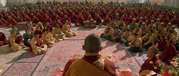 Movie still from “Kundun” (1997), directed by Martin Scorsese – Many monks sitting in a large group; Wide shot, High angle