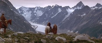 Movie still from “Kundun” (1997), directed by Martin Scorsese – Two people on a horse looking out over a mountain valley; Extreme Wide shot, High angle