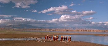 Movie still from “Kundun” (1997), directed by Martin Scorsese – A group of people standing next to a body of water; Extreme Wide shot, High angle