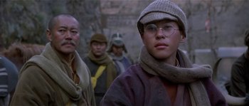 Movie still from “Kundun” (1997), directed by Martin Scorsese – A group of men standing next to each other; Close Up shot, Low angle