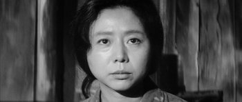 Movie still from “Black Cat” (1968), directed by Kaneto Shindô – An asian woman is looking at the camera; Close Up shot, Low angle