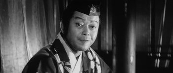 Movie still from “Black Cat” (1968), directed by Kaneto Shindô – An old photo of a man wearing a hat; Close Up shot, Low angle