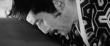 Movie still from “Black Cat” (1968), directed by Kaneto Shindô – A person's face with sweat on his face; Close Up shot, Low angle