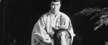 Movie still from “Black Cat” (1968), directed by Kaneto Shindô – A man in a kimono sitting on top of a horse; Close Up shot, Low angle