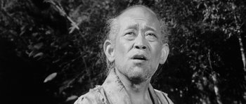 Movie still from “Black Cat” (1968), directed by Kaneto Shindô – An older man with a beard and a mustache; Close Up shot, Low angle