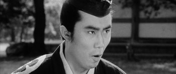 Movie still from “Black Cat” (1968), directed by Kaneto Shindô – A black and white photo of a man with a mustache; Close Up shot, Low angle