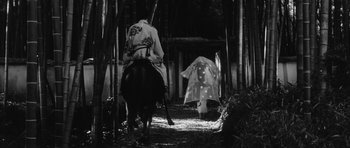 Movie still from “Black Cat” (1968), directed by Kaneto Shindô – Two people on horseback walking down a path; Wide shot, Low angle