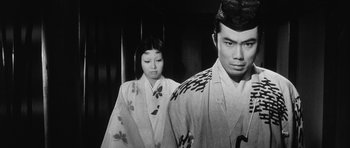 Movie still from “Black Cat” (1968), directed by Kaneto Shindô – A man and a woman in traditional japanese garb; Medium shot, Low angle