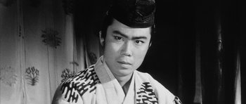 Movie still from “Black Cat” (1968), directed by Kaneto Shindô – An asian man in a black and white photo; Close Up shot, Low angle