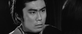 Movie still from “Black Cat” (1968), directed by Kaneto Shindô – A man's face in a black and white photo; Extreme Close Up shot, Low angle