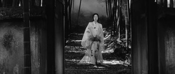 Movie still from “Black Cat” (1968), directed by Kaneto Shindô – A woman in a kimono standing in the woods; Wide shot, Low angle
