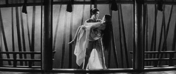 Movie still from “Black Cat” (1968), directed by Kaneto Shindô – A man and a woman dancing on a stage; Wide shot, Low angle