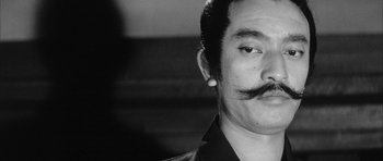 Movie still from “Black Cat” (1968), directed by Kaneto Shindô – A person with a mustache; Close Up shot, Low angle