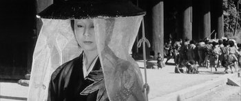 Movie still from “Black Cat” (1968), directed by Kaneto Shindô – A woman in a kimono holding an umbrella over her head; Close Up shot, Low angle