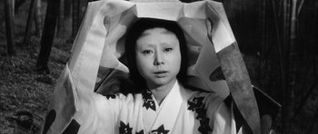 Movie still from “Black Cat” (1968), directed by Kaneto Shindô – A woman in a kimono with a paper bag on her head; Close Up shot, High angle
