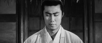 Movie still from “Black Cat” (1968), directed by Kaneto Shindô – A black and white photo of a man with his eyes closed; Close Up shot, Low angle