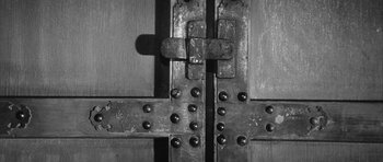 Movie still from “Black Cat” (1968), directed by Kaneto Shindô – A black and white photo of a metal door; Extreme Close Up shot, Overhead angle