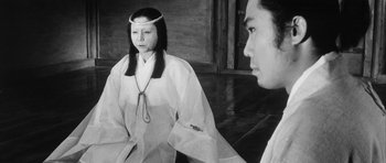 Movie still from “Black Cat” (1968), directed by Kaneto Shindô – A woman in a white robe and a man in a white robe; Medium shot, Over the shoulder angle