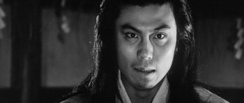 Movie still from “Black Cat” (1968), directed by Kaneto Shindô – A person with long black hair; Close Up shot, Low angle