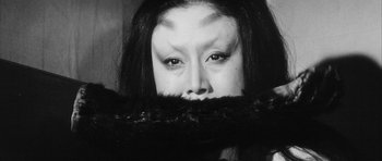 Movie still from “Black Cat” (1968), directed by Kaneto Shindô – A black and white photo of a woman with her mouth open; Close Up shot, High angle