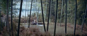 Movie still from “Kwaidan” (1964), directed by Masaki Kobayashi – A man sitting on a raft in the middle of a river; Extreme Wide shot, High angle