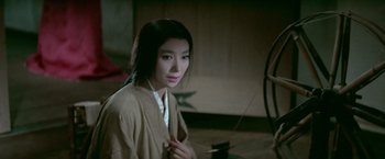 Movie still from “Kwaidan” (1964), directed by Masaki Kobayashi – A young asian woman in traditional clothing in an oriental setting; Medium shot, High angle