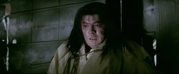 Movie still from “Kwaidan” (1964), directed by Masaki Kobayashi – A man with long black hair and a white shirt; Close Up shot, Low angle