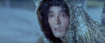 Movie still from “Kwaidan” (1964), directed by Masaki Kobayashi – A man in a hooded jacket looking into the camera; Close Up shot, High angle