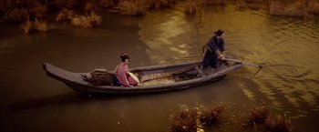 Movie still from “Kwaidan” (1964), directed by Masaki Kobayashi – Two people in a boat on a body of water; Wide shot, High angle