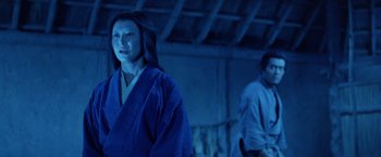 Movie still from “Kwaidan” (1964), directed by Masaki Kobayashi – A woman in a blue robe standing next to a man in a blue robe; Medium shot, Low angle