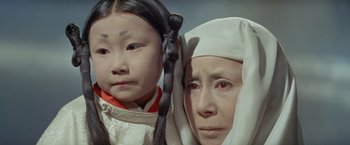 Movie still from “Kwaidan” (1964), directed by Masaki Kobayashi – An older woman and a young girl are looking at the camera; Close Up shot, High angle