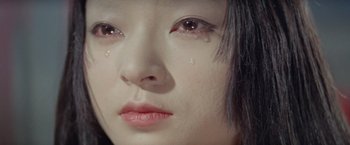Movie still from “Kwaidan” (1964), directed by Masaki Kobayashi – A person with tears in their eyes; Extreme Close Up shot, High angle