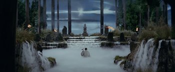 Movie still from “Kwaidan” (1964), directed by Masaki Kobayashi – A man sitting on the ground in front of a waterfall; Extreme Wide shot, High angle