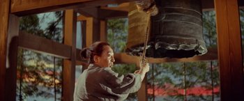 Movie still from “Kwaidan” (1964), directed by Masaki Kobayashi – A man is pulling a rope from the ceiling of a building; Medium shot, Low angle