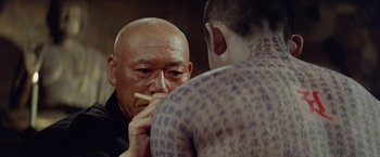 Movie still from “Kwaidan” (1964), directed by Masaki Kobayashi – An older man is eating a piece of food from a young man's hand; Close Up shot, Over the shoulder angle