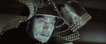 Movie still from “Kwaidan” (1964), directed by Masaki Kobayashi – A person wearing a helmet; Close Up shot, Low angle