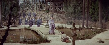 Movie still from “Kwaidan” (1964), directed by Masaki Kobayashi – A man dressed in a kimono is standing on a bridge; Wide shot, High angle